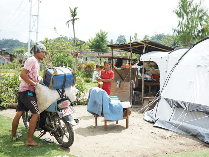 Family in front of a ShelterBox tent