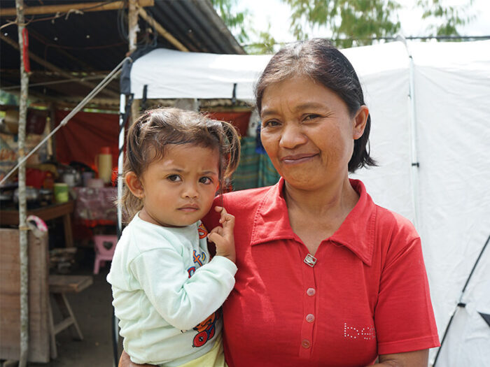 Woman holding a child in Indonesia
