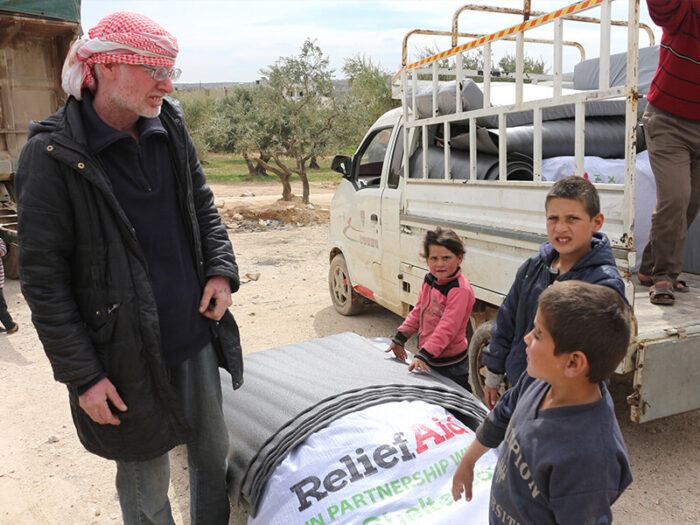 A family is receiving tools to build a shelter