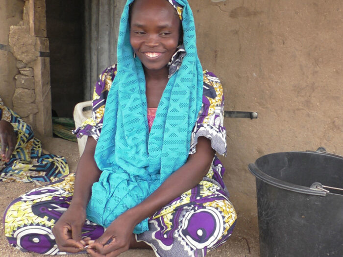 Woman in bright blue scarf smiling