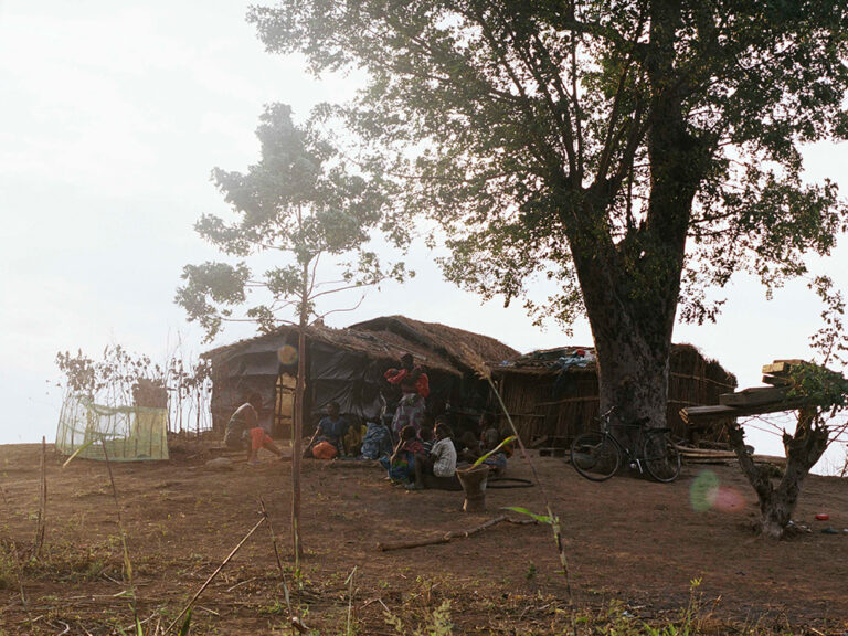 A family sits outside their home