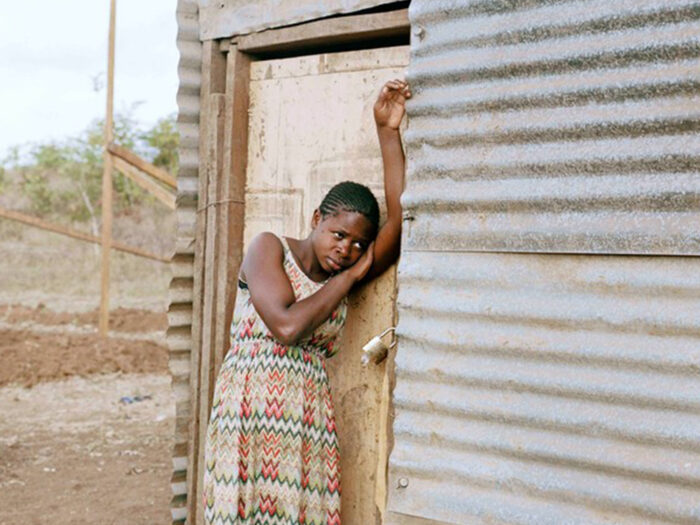 girl leaning against a door