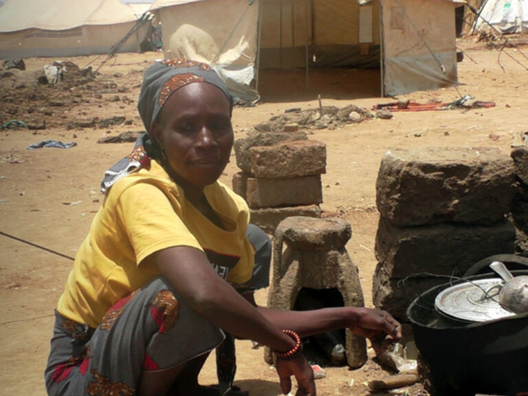 Woman squatting down with a kitchen set