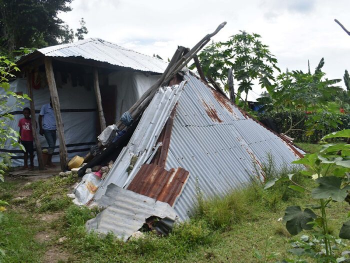 A makeshift tent made out of sheet metal and wood