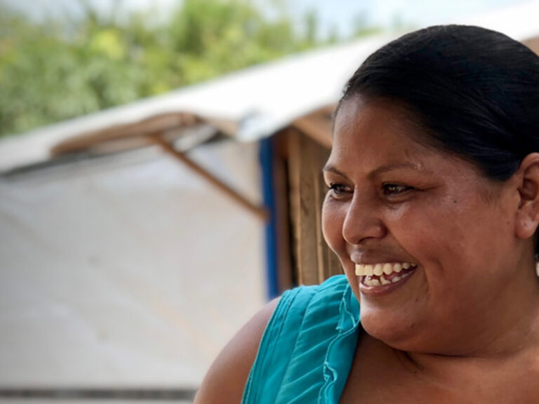 Woman with a green top smiling
