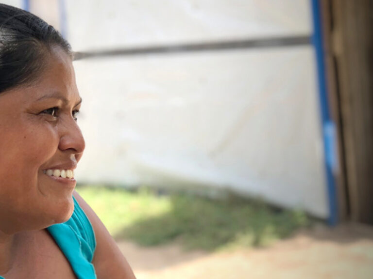 Woman with a green top smiling