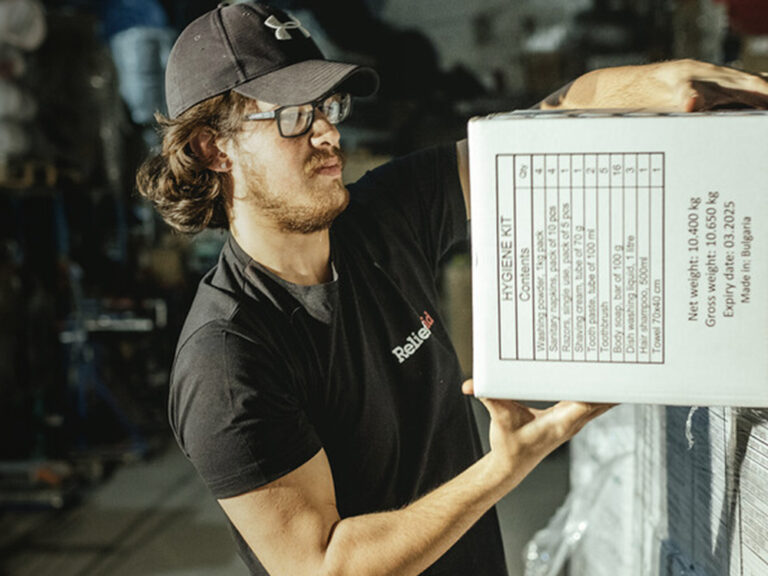 Man unloading boxes at a warehouse.