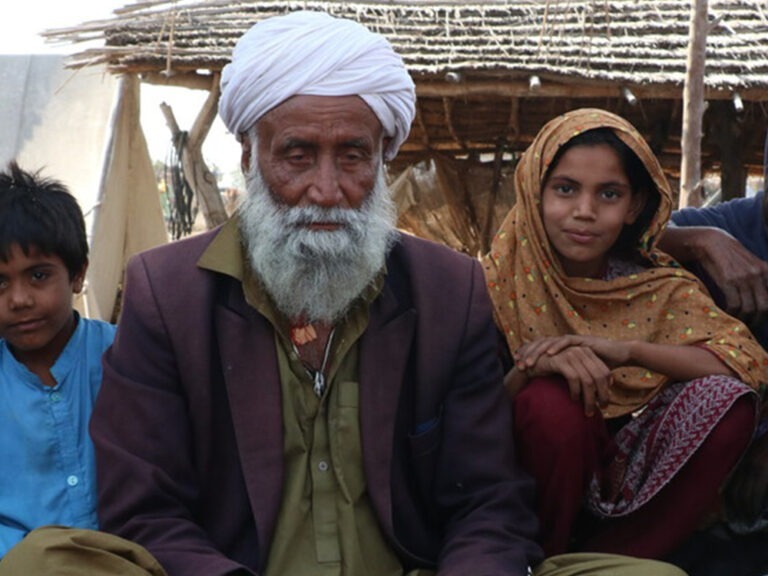 A man sitting with his family
