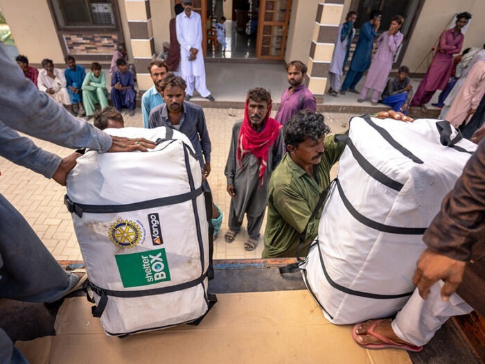 Workers unloading tents from a truck, to give to community members