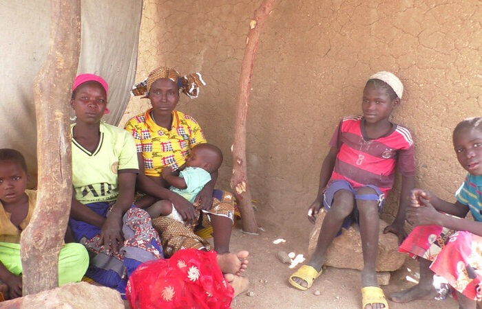 Women and children sitting on the ground