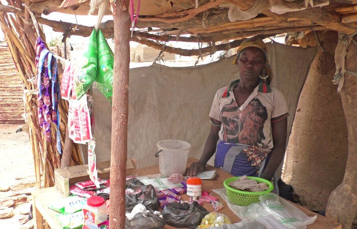 Woman standing behind a shop counter in Cameroon