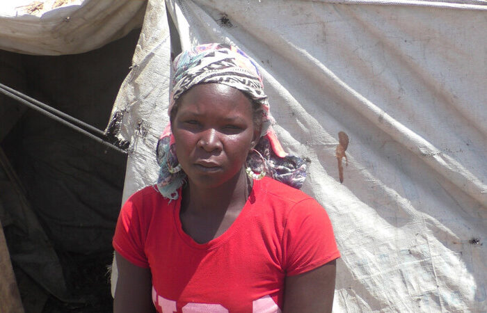 Woman sitting outside a tent