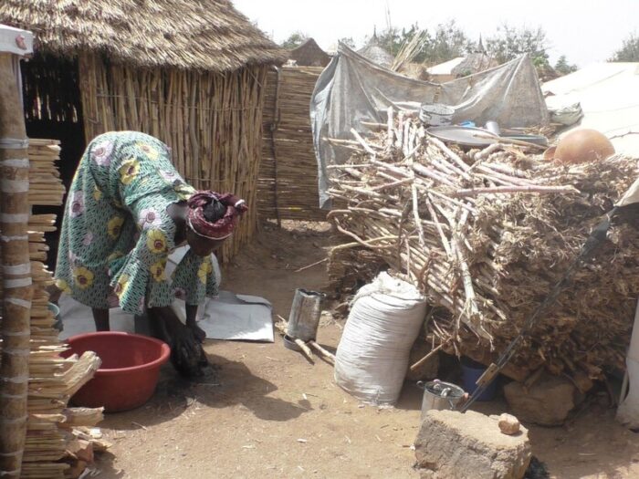 Woman outside a home in Cameroon