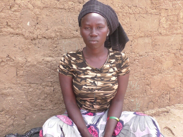 A woman sitting and looking at the camera