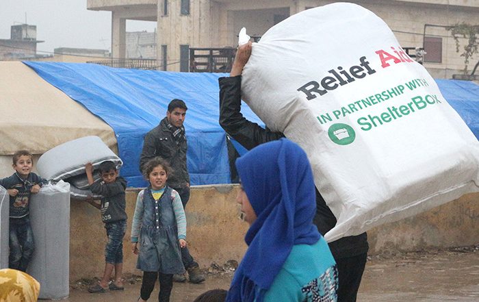 Person carrying bag of aid in Syria