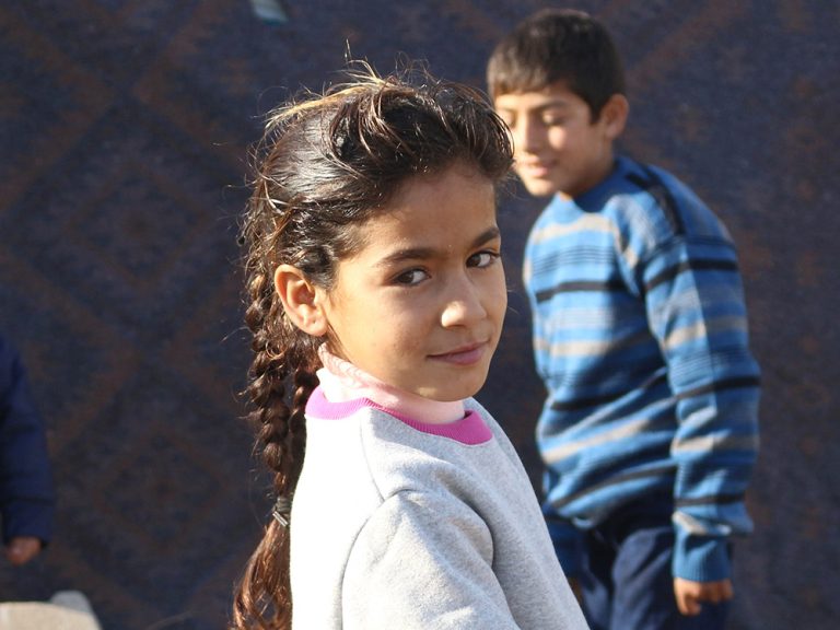 Children outside a tent in Syria