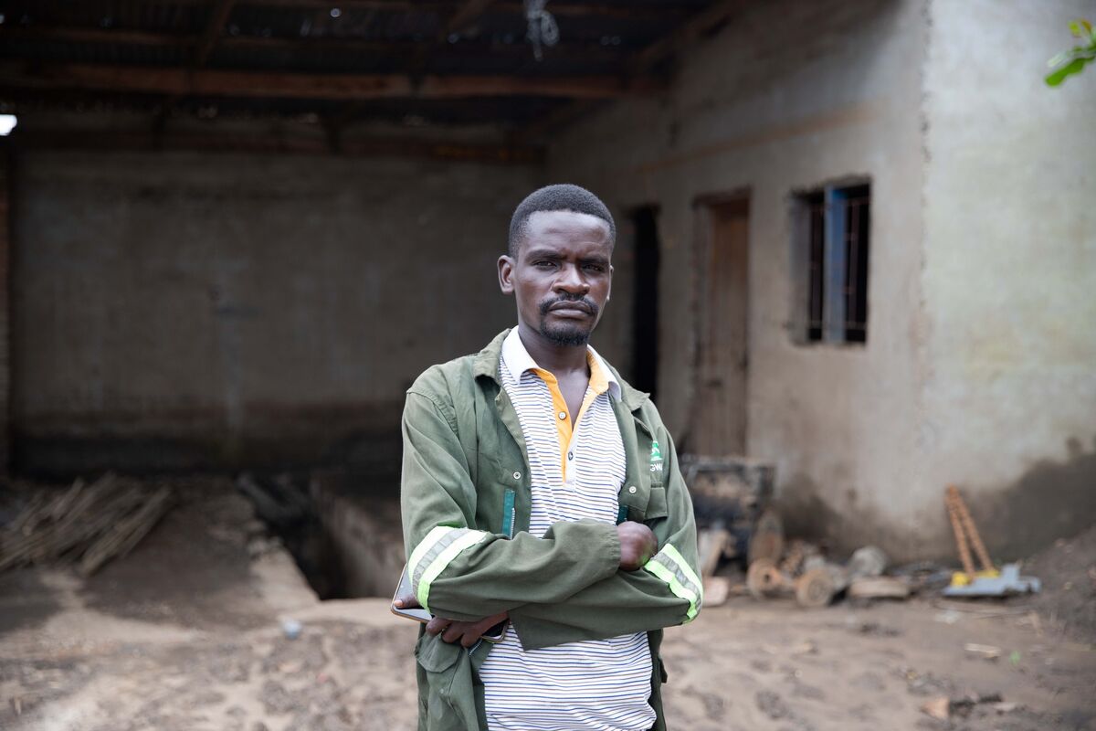 Man standing outside a damaged building in Malawi