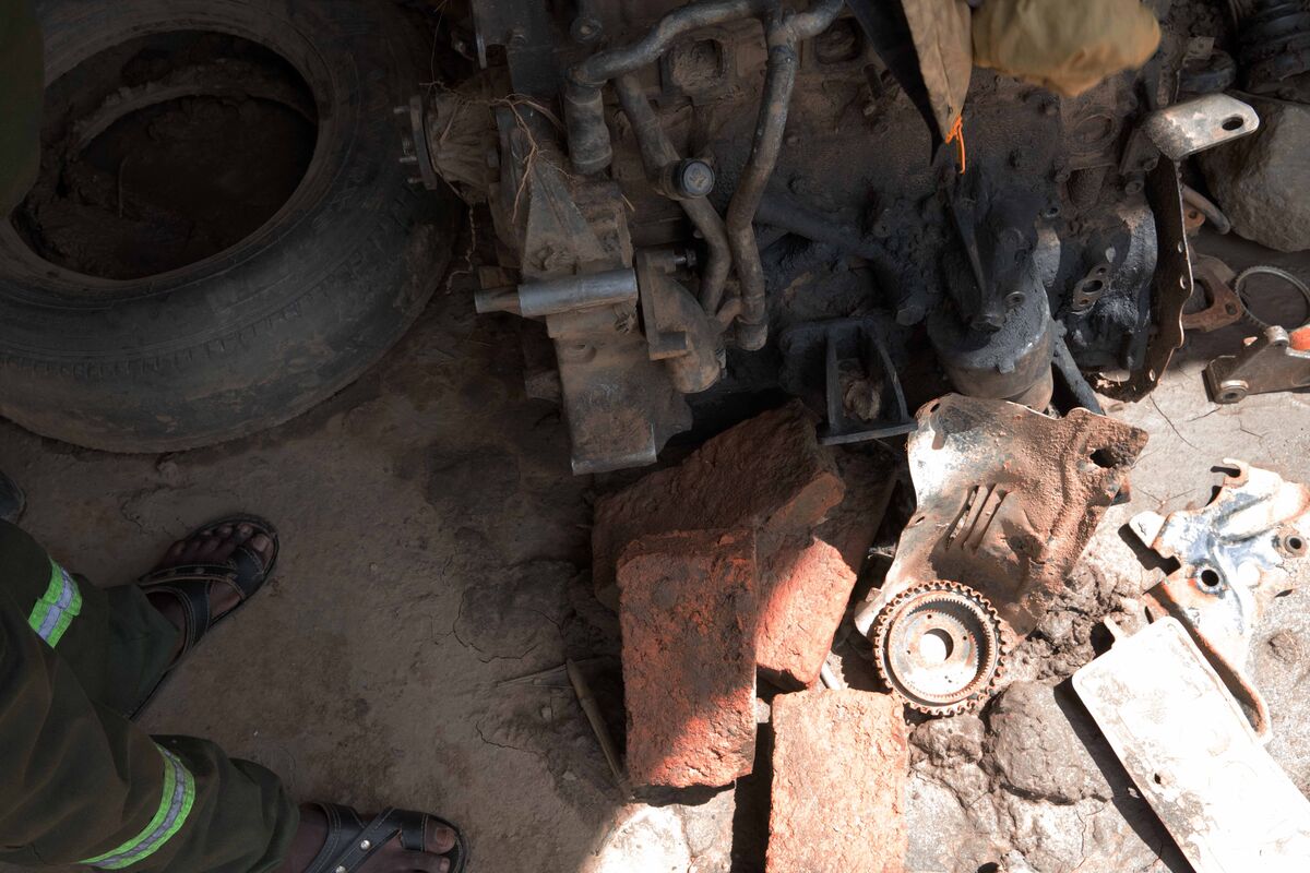 Damaged car parts on the floor in a garage
