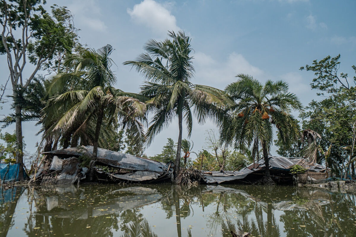 Collapsed buildings next to floodwater in Bangladesh