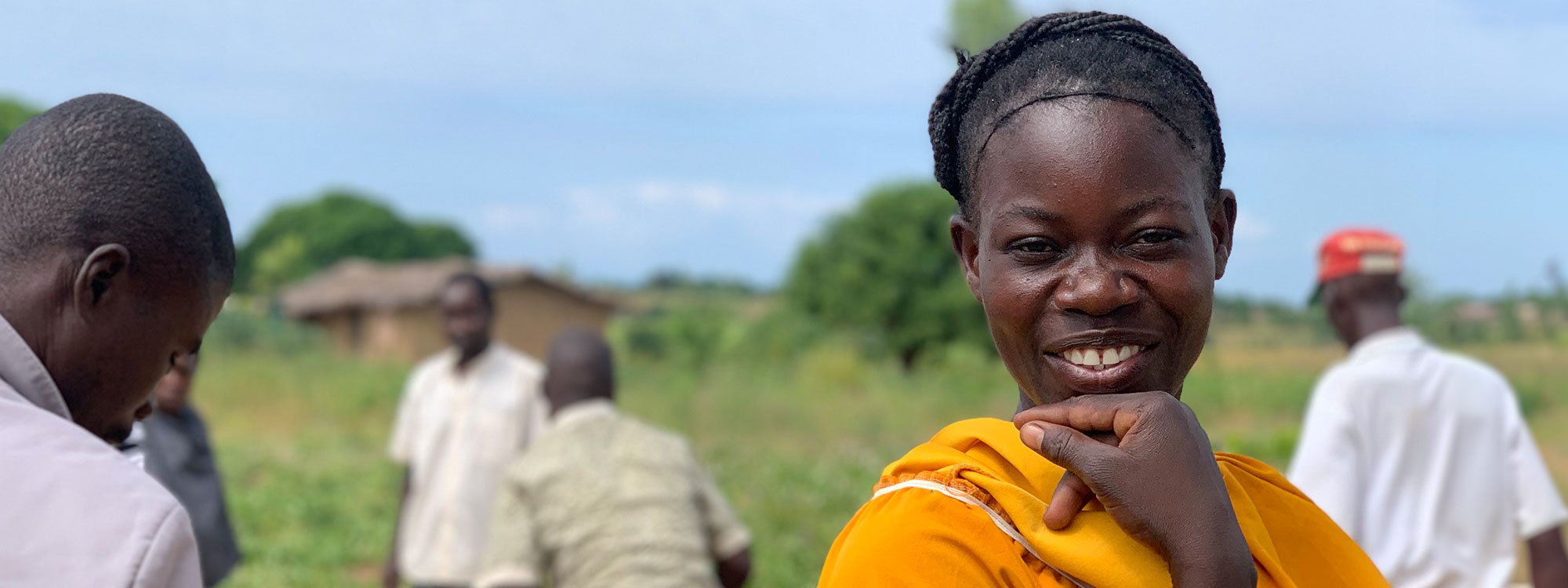 Smiling Malawian woman dressed in orange