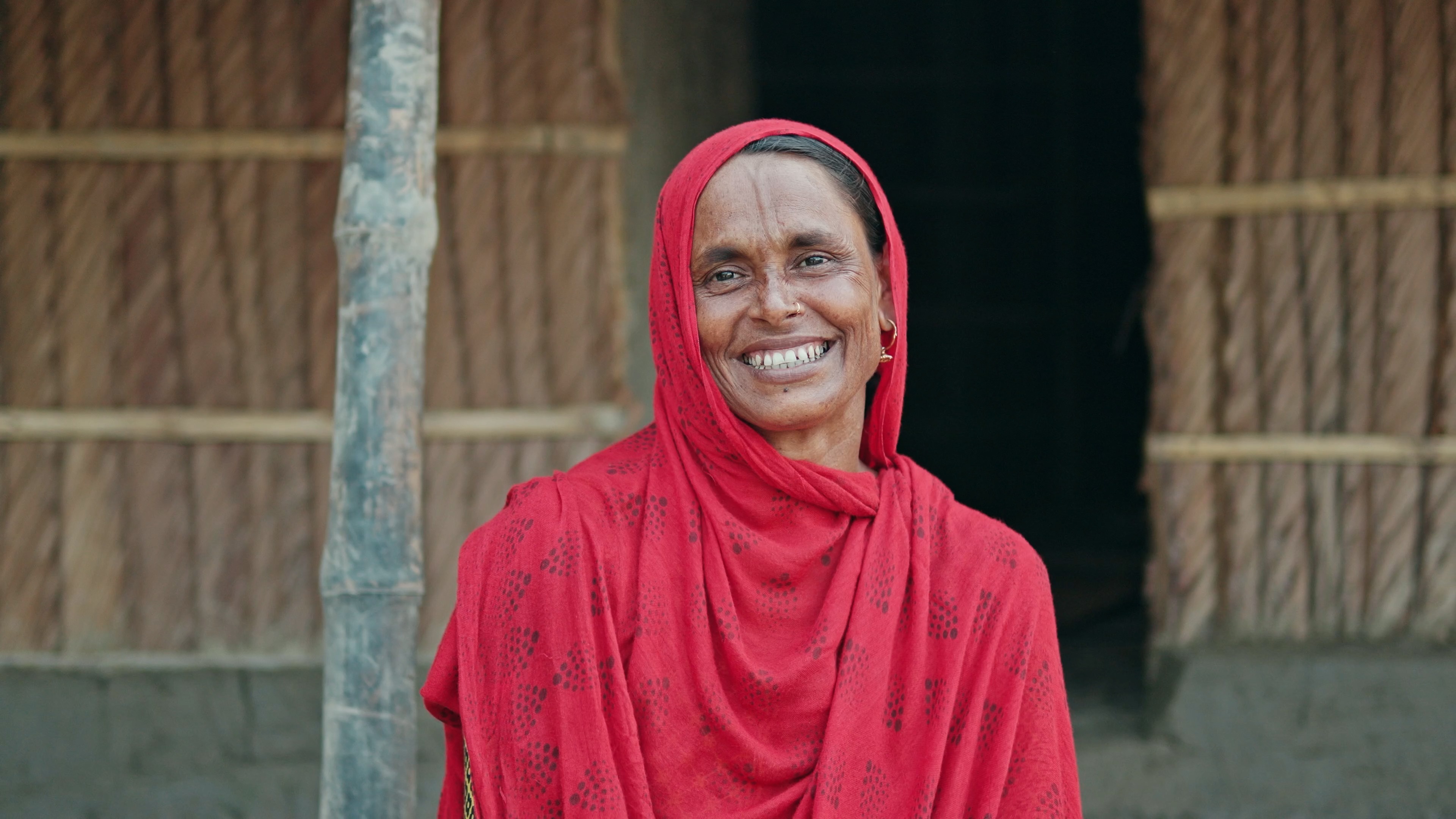 A woman smiling after recovering from a Cyclone.