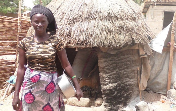 A woman standing outside an emergency shelter in Cameroon.