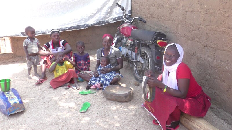 Women sat down with children in Cameroon.