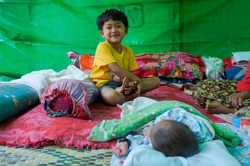 A baby and child in an emergency shelter.
