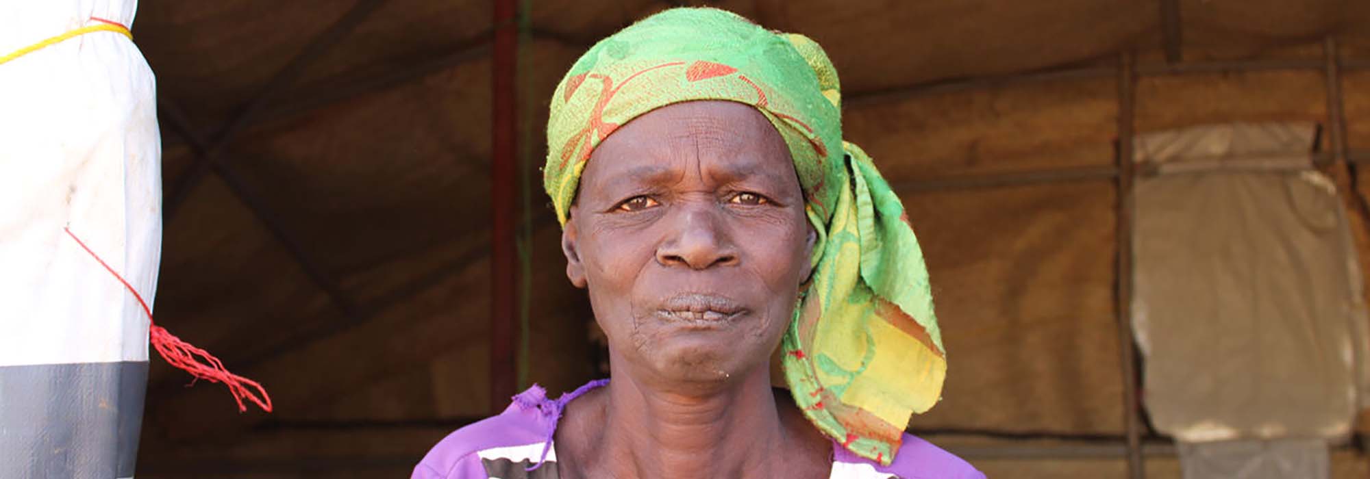 A woman sitting in an emergency shelter.
