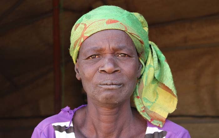 A woman sitting in an emergency shelter.