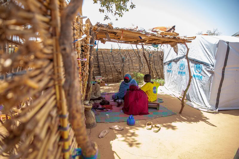 A family sitting in the shade.